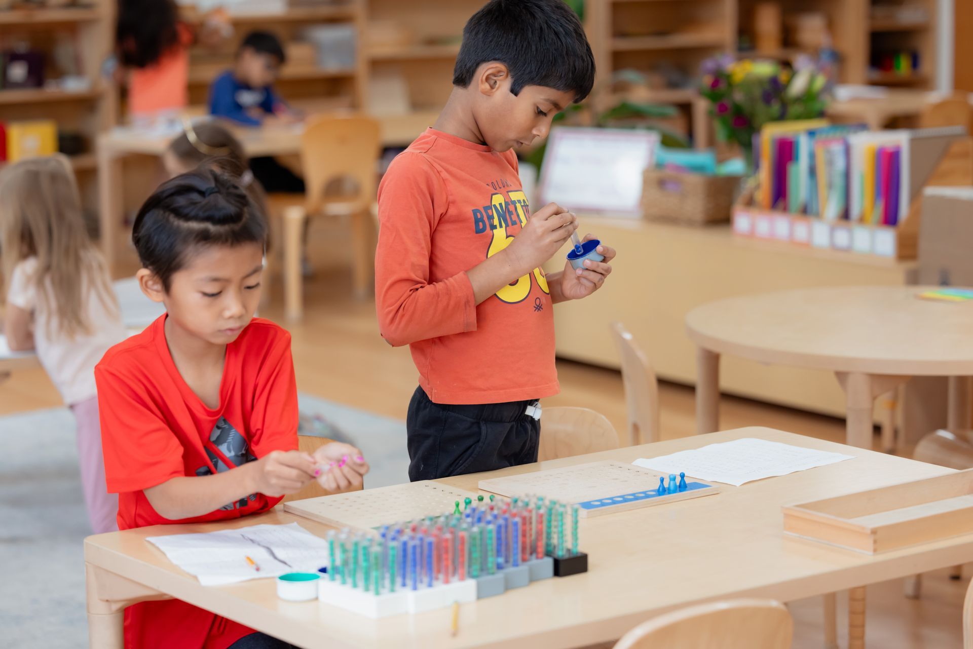 Montessori children working with beads material