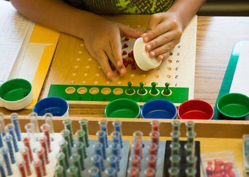 Student working with Montessori math materials