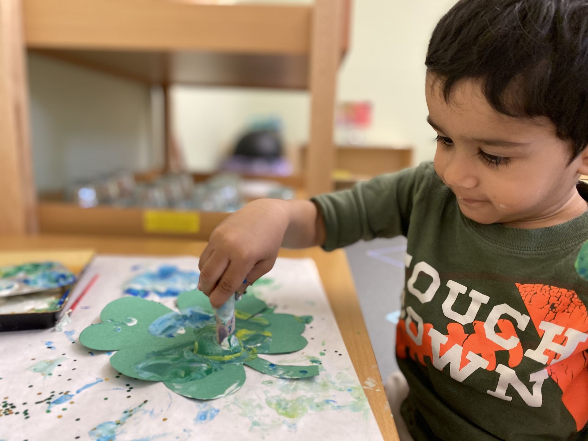Montessori child grabbing a color pencil