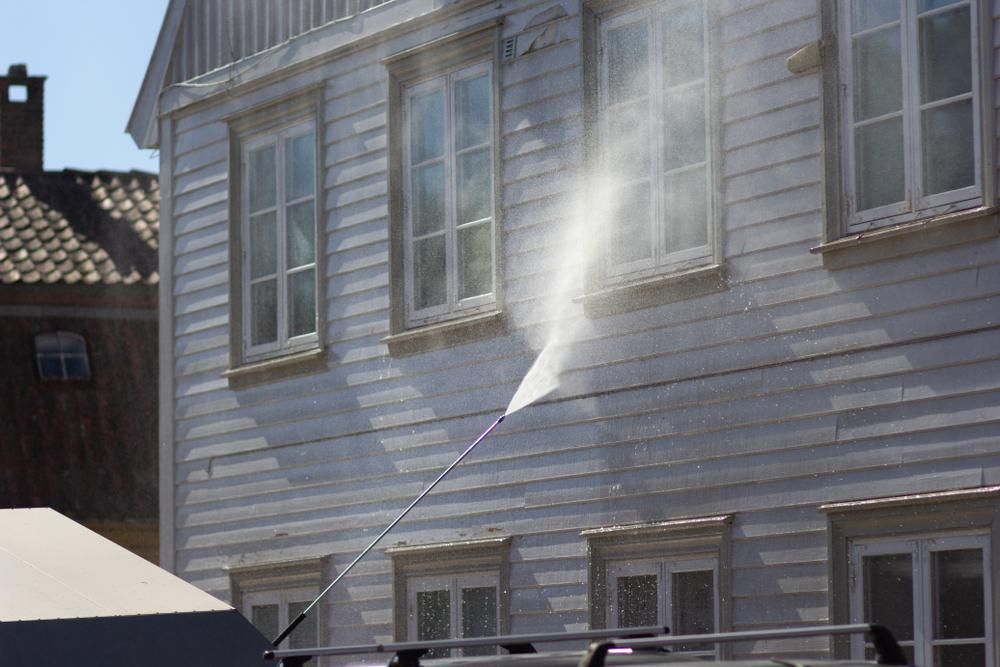 A Pressure Washer Used To Clean The Side Of A Building — Cairns Bin Cleaning In Parramatta Park, QLD