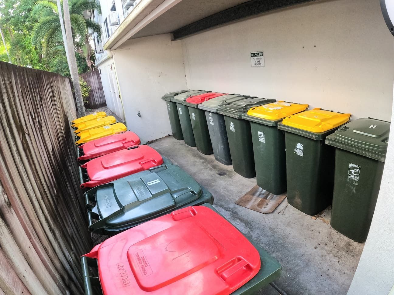 A Bunch of Trash Cans Are Lined up In a Row — Cairns Bin Cleaning In Parramatta Park, QLD