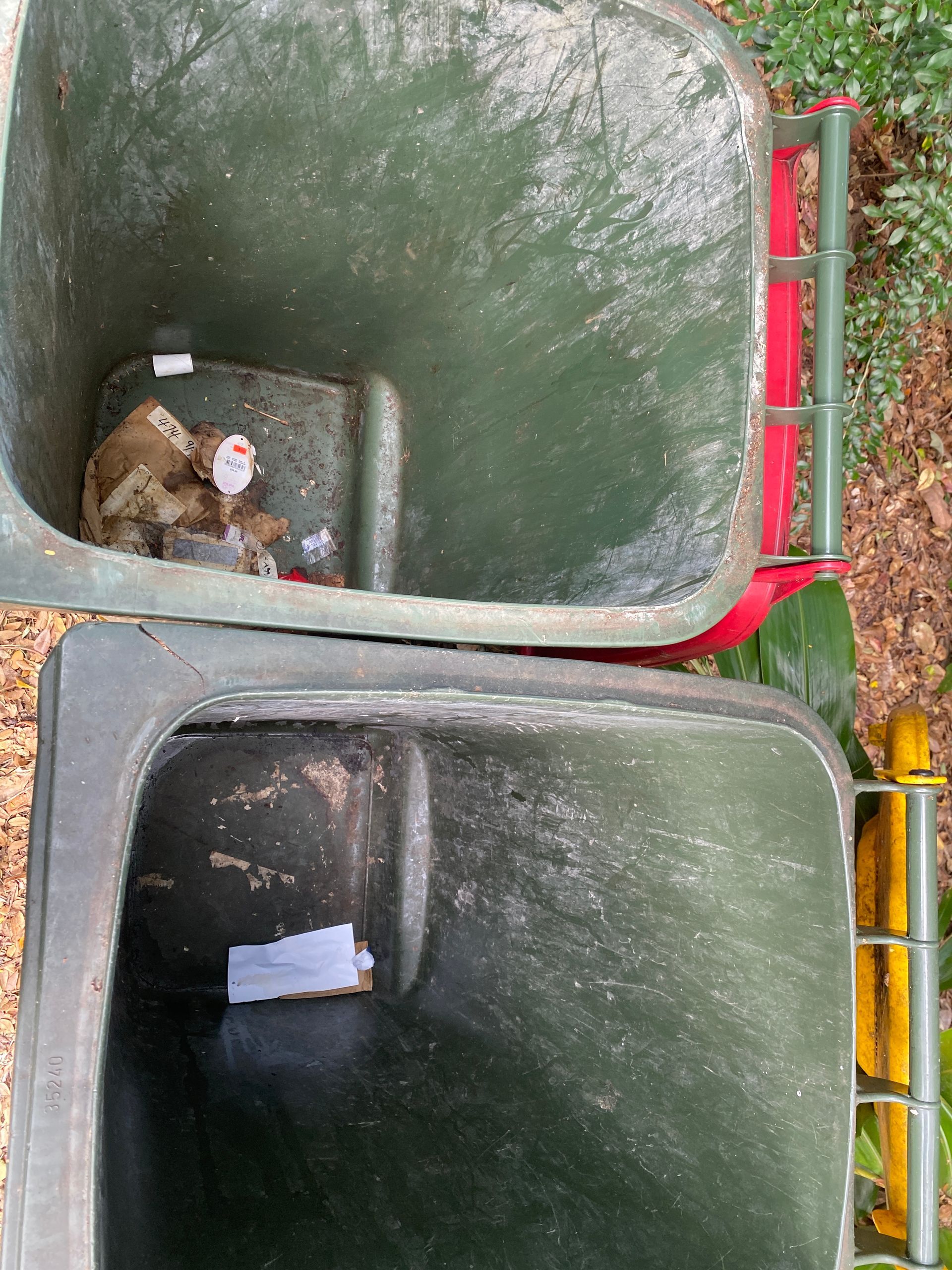A Person Is Cleaning A Trash Can With A High Pressure Washer — Cairns Bin Cleaning In Parramatta Park, QLD