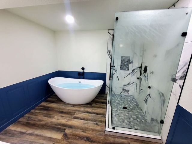 Modern freestanding bathtub with a white towel in a bright bathroom