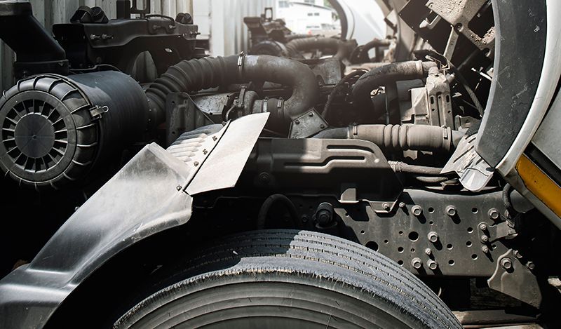 A close up of a truck engine with the hood open