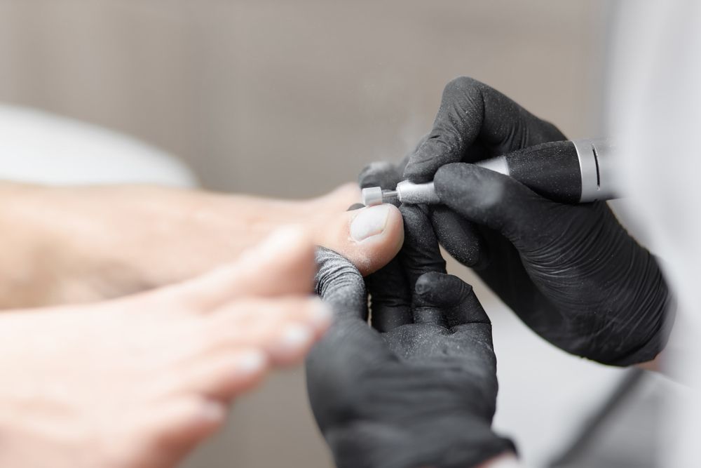 Person's Foot Receiving a Pedicure — Pink Lily Beauty in Blacksmiths, NSW