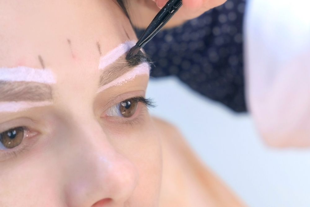 Person Receiving an Eyebrow Treatment — Pink Lily Beauty in Blacksmiths, NSW