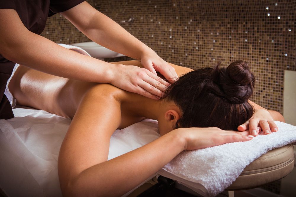 Person Receiving a Back Massage in A Spa — Pink Lily Beauty in Blacksmiths, NSW