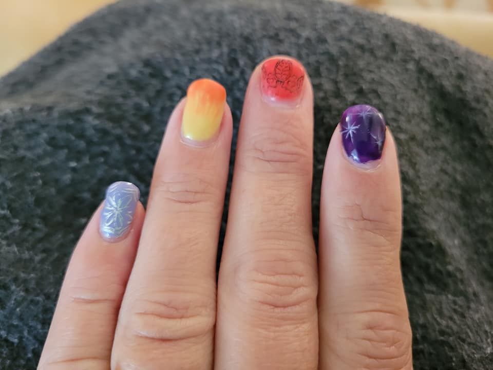Hand with Rainbow-Colored Nail Polish — Pink Lily Beauty in Blacksmiths, NSW