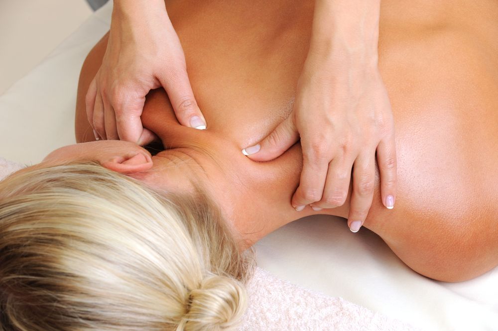 Person Receiving a Back Massage in A Spa — Pink Lily Beauty in Blacksmiths, NSW