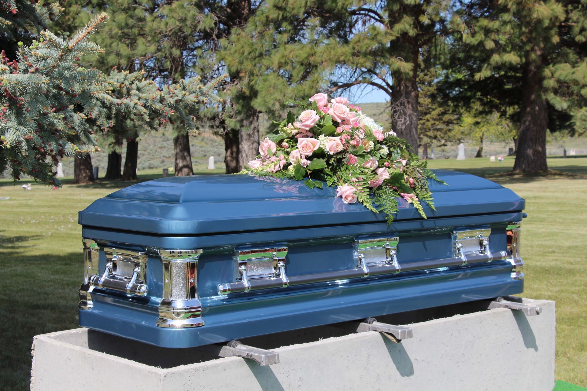A wooden coffin with flowers on top of it in a church.