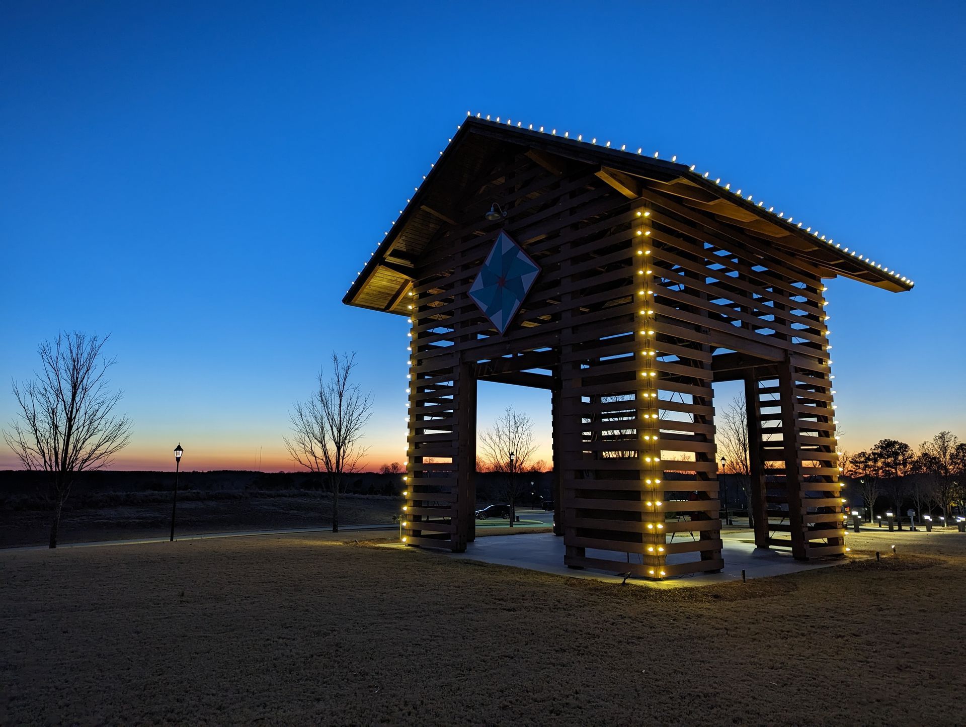 A wooden structure with lights on it is lit up at night