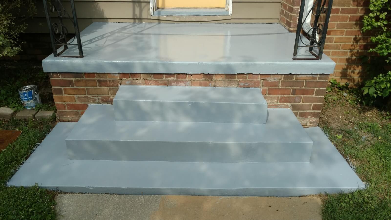 A set of stairs leading up to a brick house.