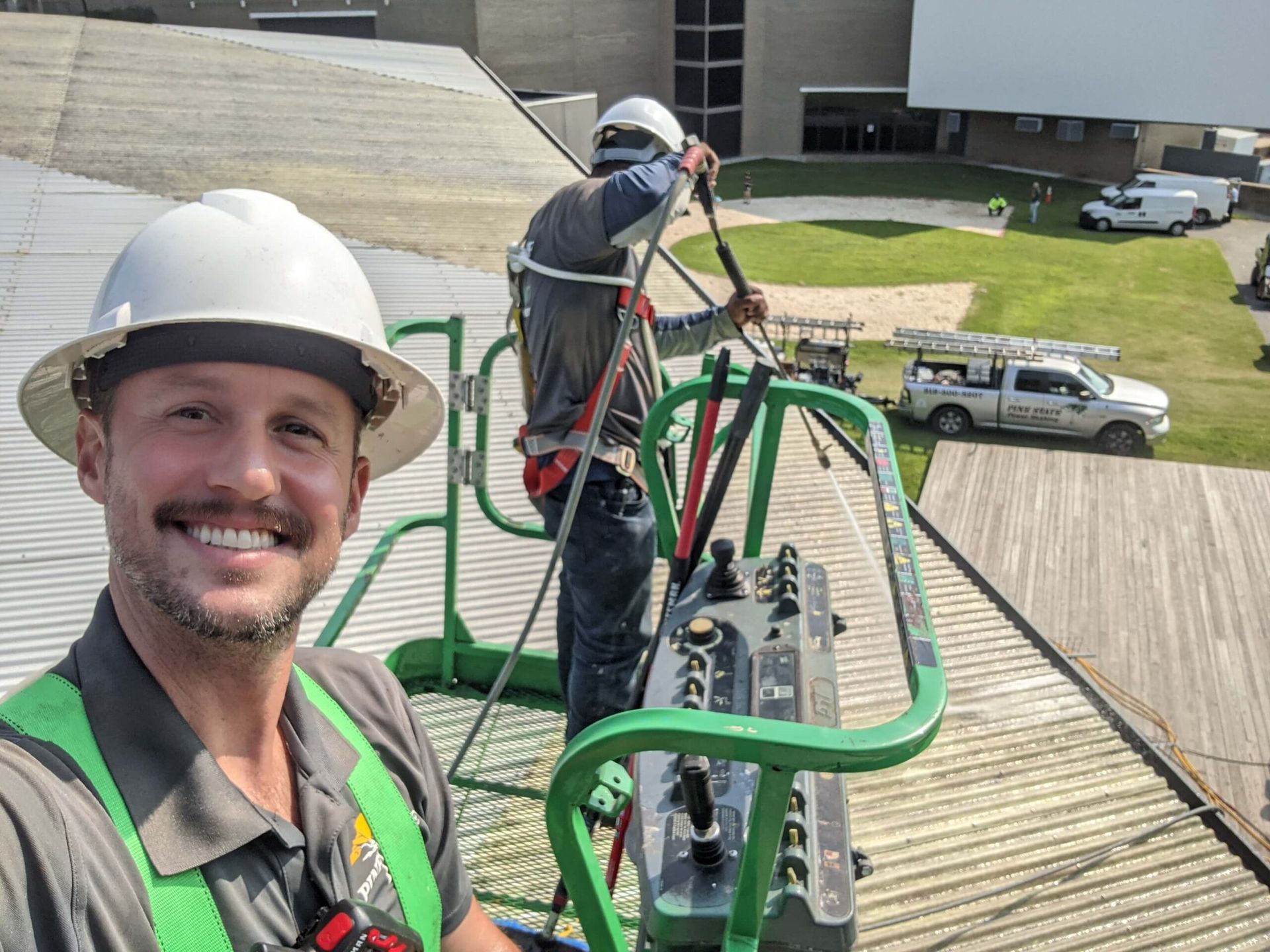 Pinestate Pro Wash owner David Berry on a crane washing the roof of the art amphitheater in Raleigh, NC