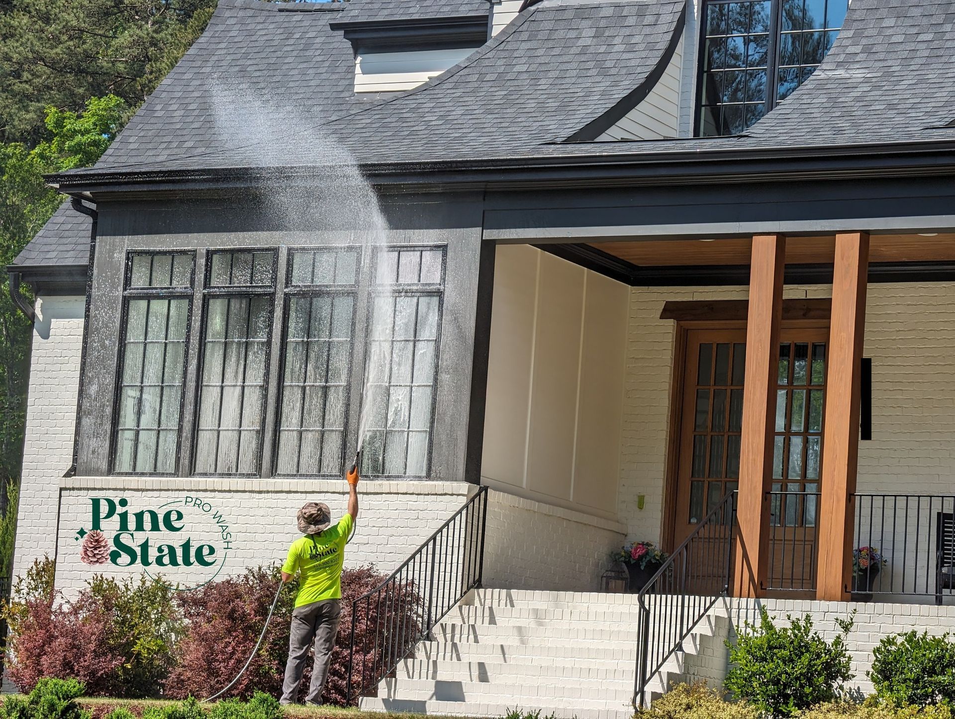A man is cleaning the windows of a house.