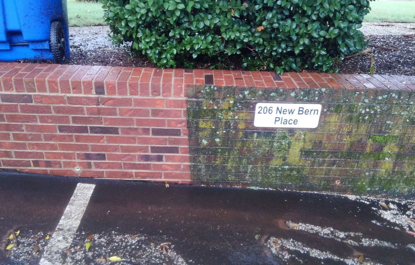 A brick wall split between clean, red brick on the left and moss-covered, dark brick on the right, labeled