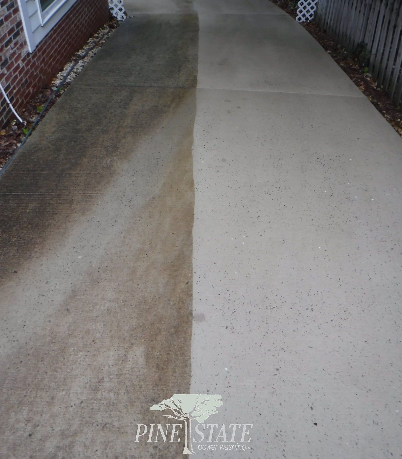 A driveway showing a clean, light-colored concrete surface on the right contrasting with a dirty, dark section on the left.