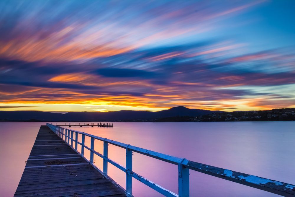 A Pier Overlooking a Lake With a Sunset in the Background — Coastal Automotive Services Long Jetty in Long Jetty, NSW