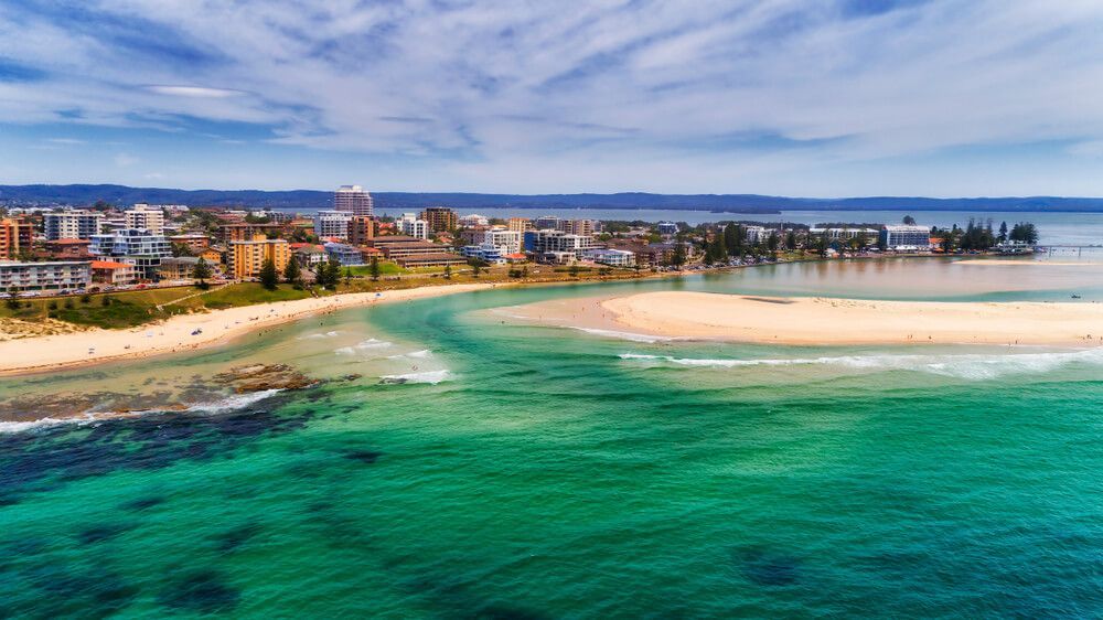 An aerial view of a beach with a city in the background — Coastal Automotive Services Long Jetty in The Entrance, NSW