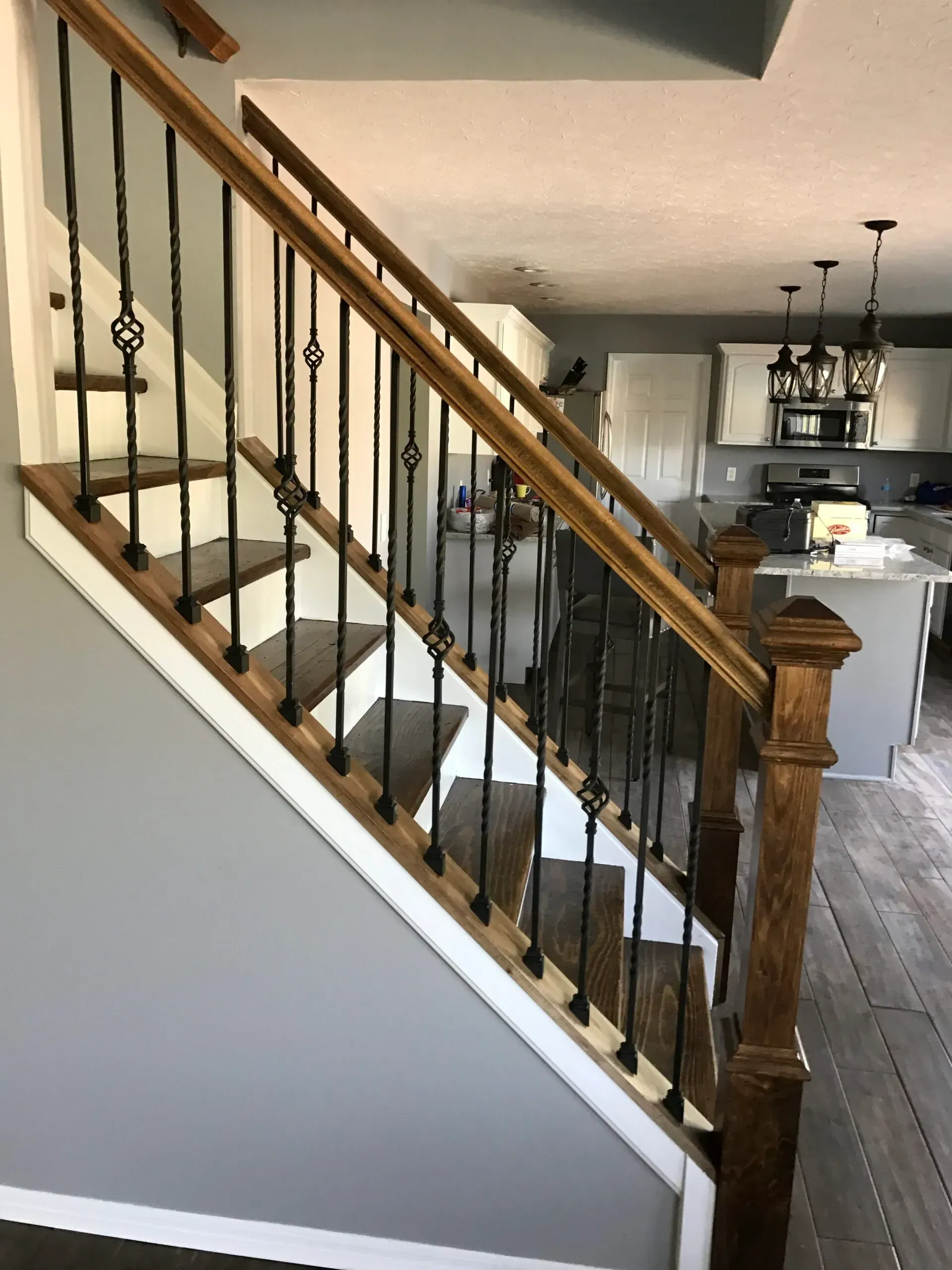 A wooden staircase with a metal railing in a house