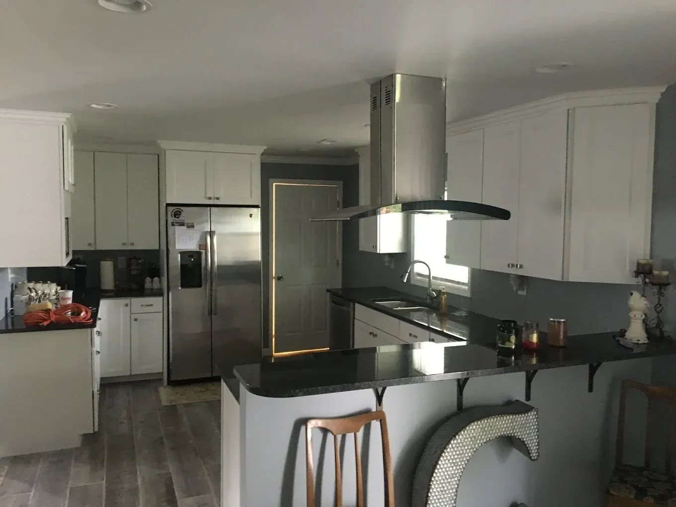A kitchen with stainless steel appliances and white cabinets