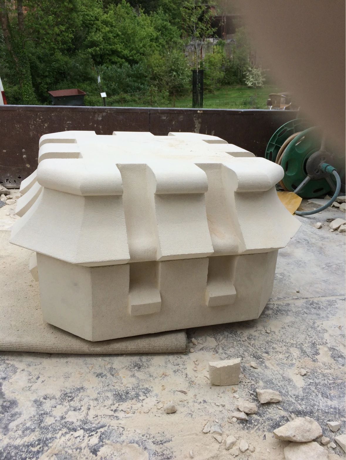 A large white object is sitting on top of a pile of rocks.