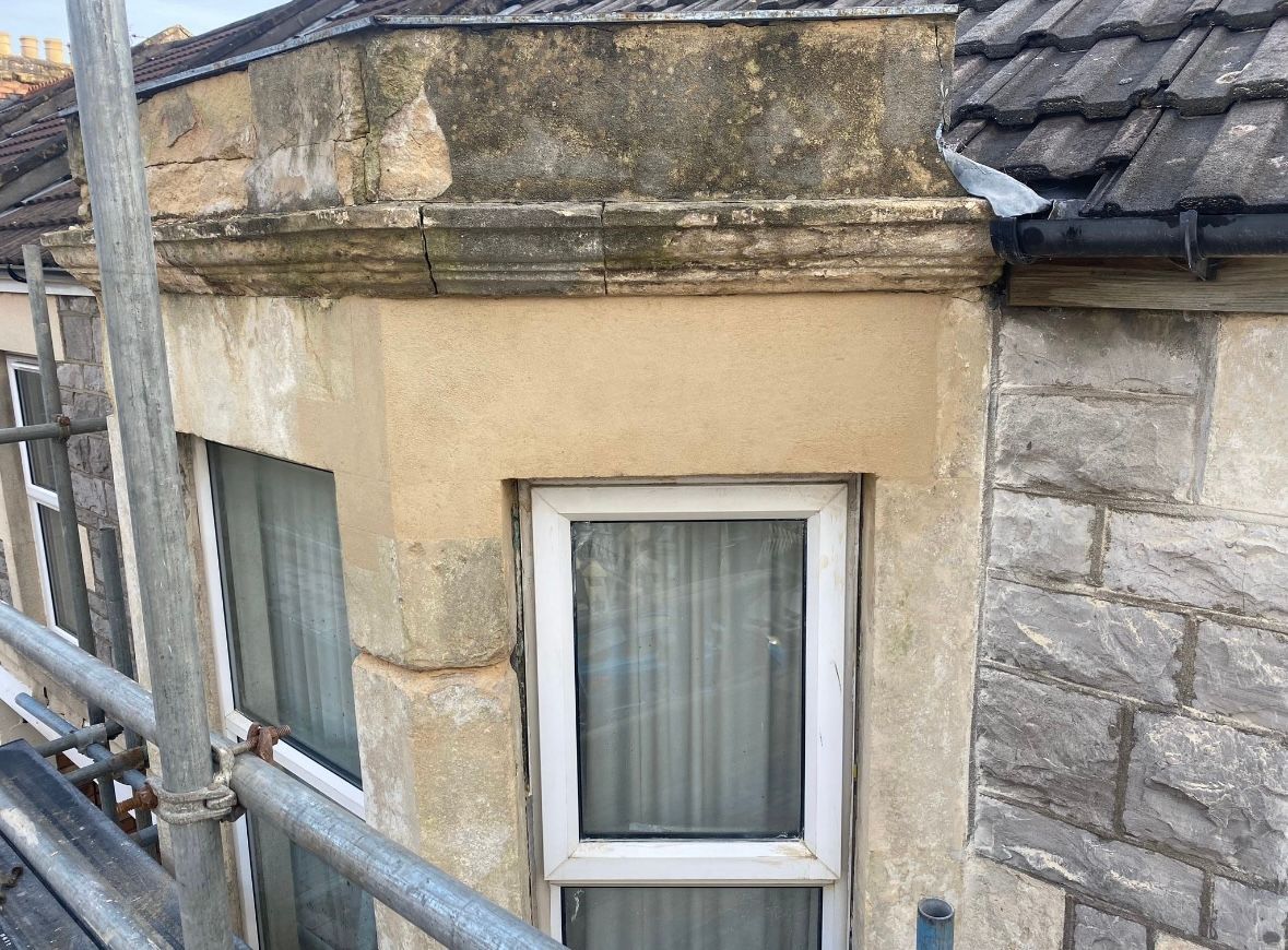 A window on the side of a building with scaffolding around it.