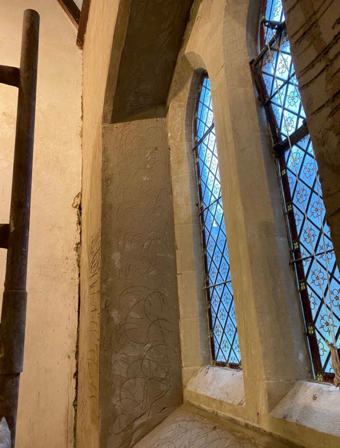 A church with stained glass windows and a scaffolding.