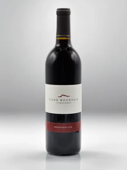 A bottle of red wine with a white label