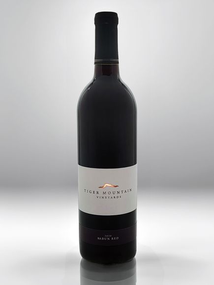 A bottle of red wine with a white label