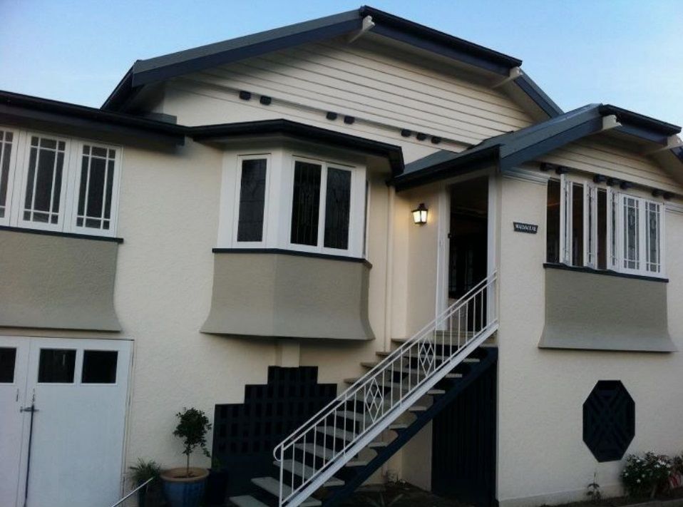 A white house with stairs leading up to the front door