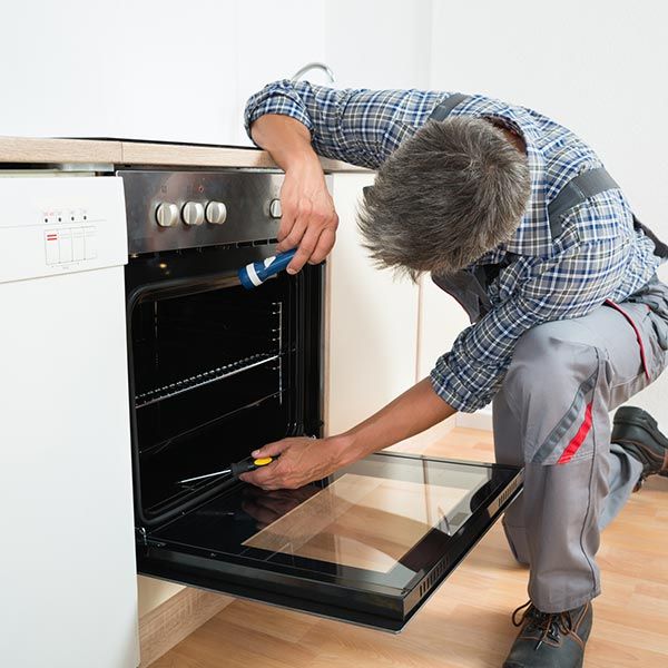 Owned — Repairman Examining Oven in Charleston, SC