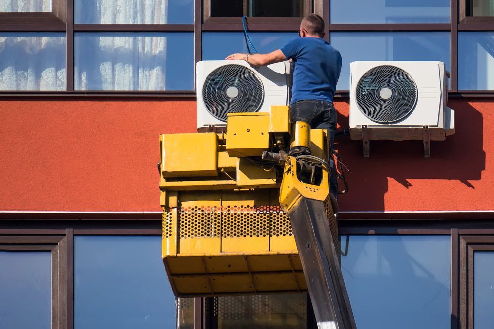 Installation of Outdoor Air Conditioning System on a Tall Building on the Crane — Air Conditioning Repairs in Nowra NSW