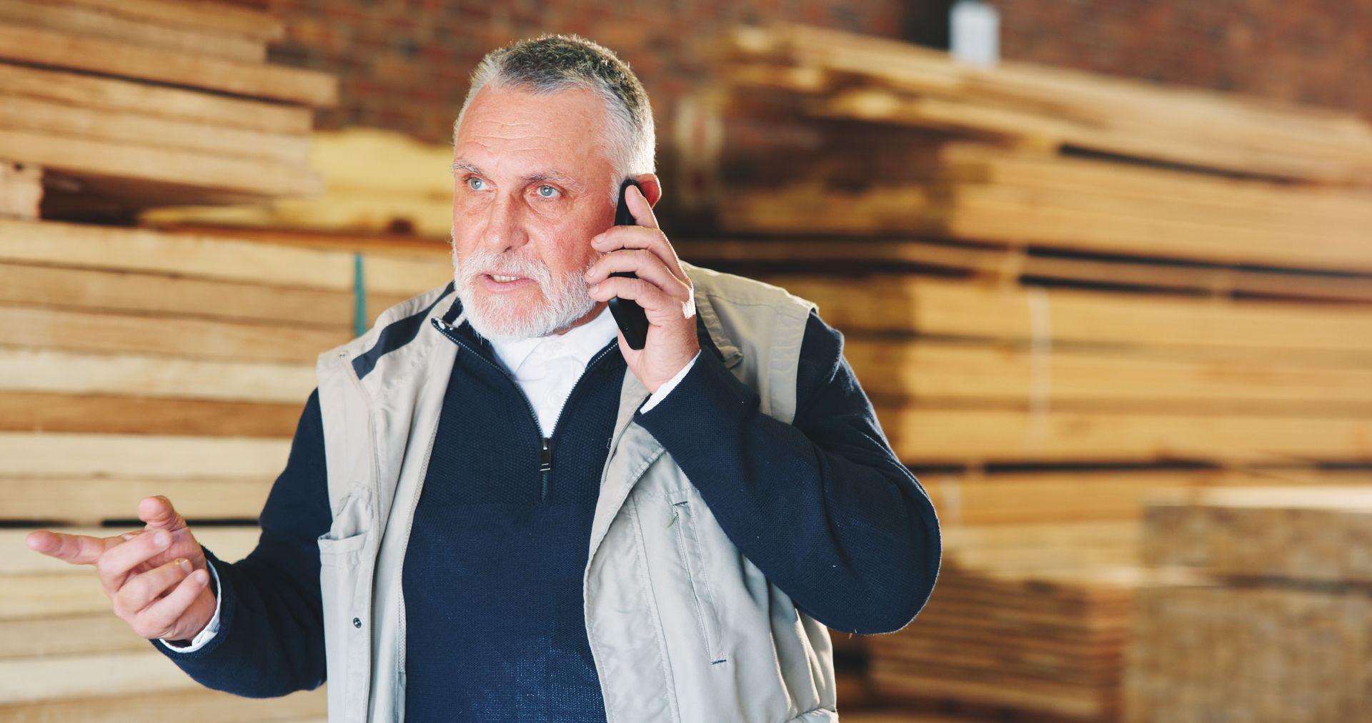 A man is talking over the phone.