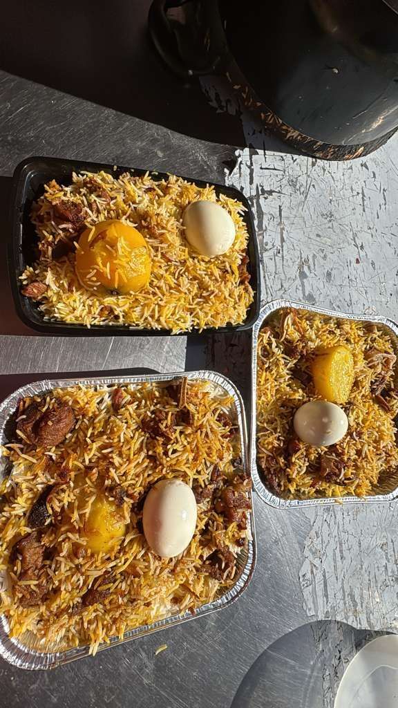 Three baked casseroles topped with breadcrumbs and eggs on a dark countertop