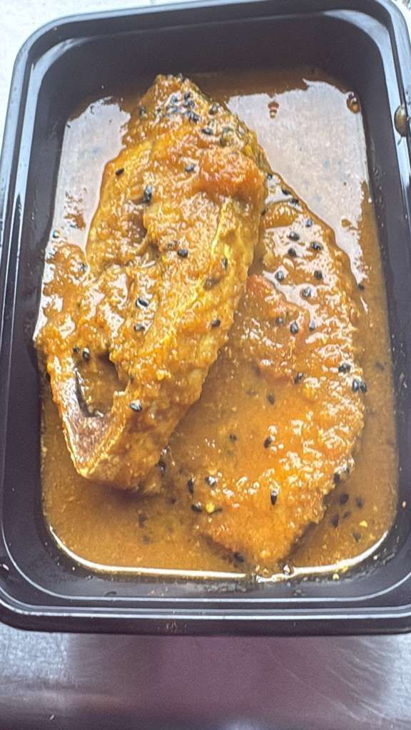 Black takeout container with two pieces of glazed saucy chicken breast.