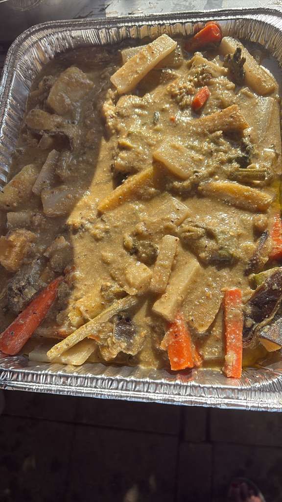 Foil tray of creamy pasta with sausage and red pepper pieces