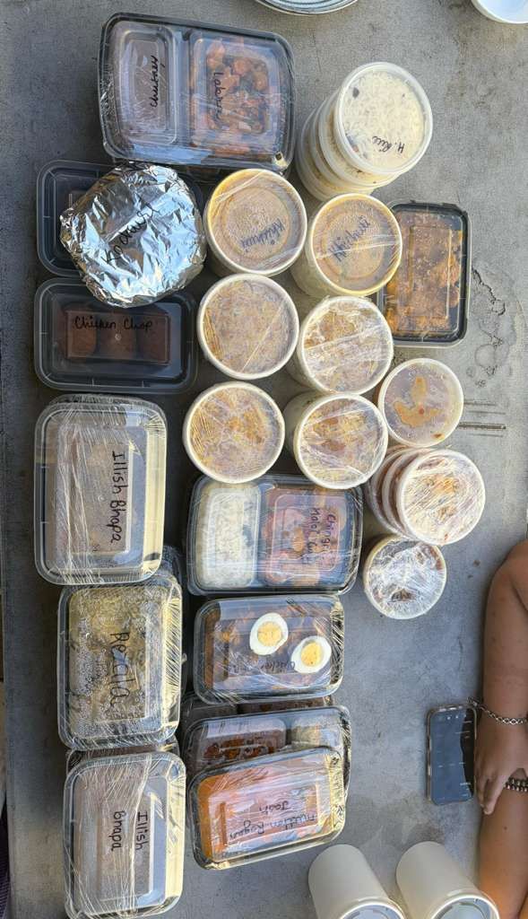 Assorted packaged food containers and cups arranged on a concrete floor.