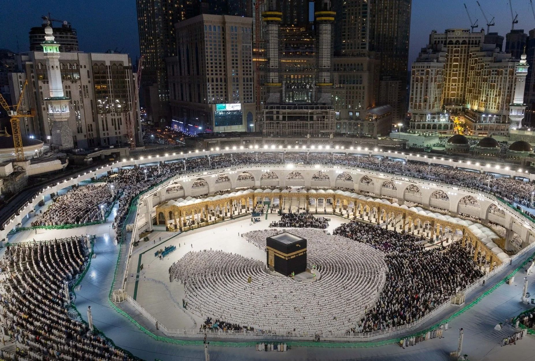 Nachtzicht op de Kaaba in Mekka met pelgrims die rond de binnenplaats van de Grote Moskee lopen.