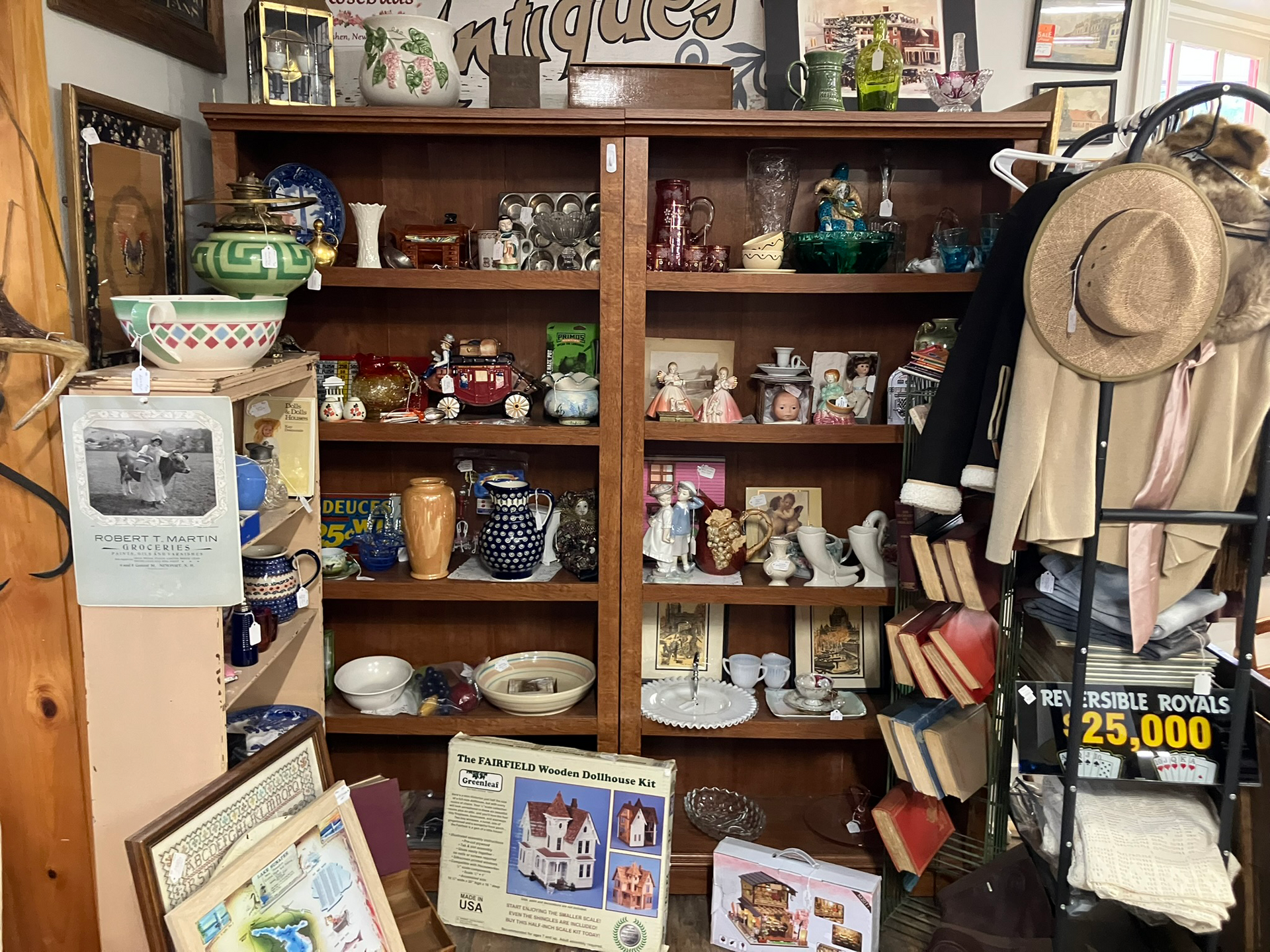 Antique shop shelves filled with pottery, figurines, books, and other vintage items.