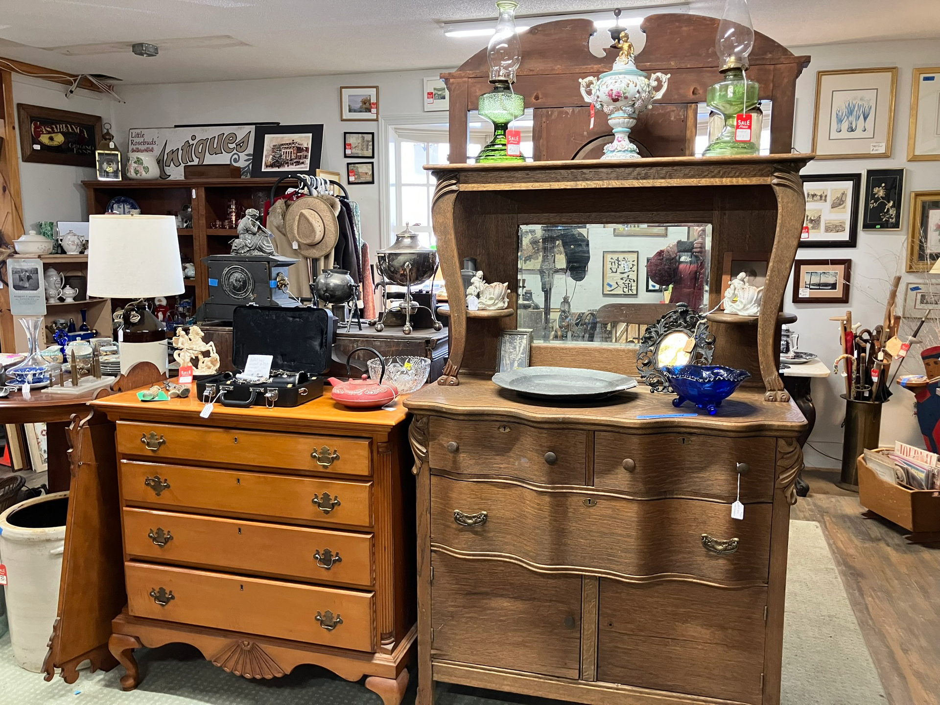 Antique shop interior with furniture, decorations, and items for sale.