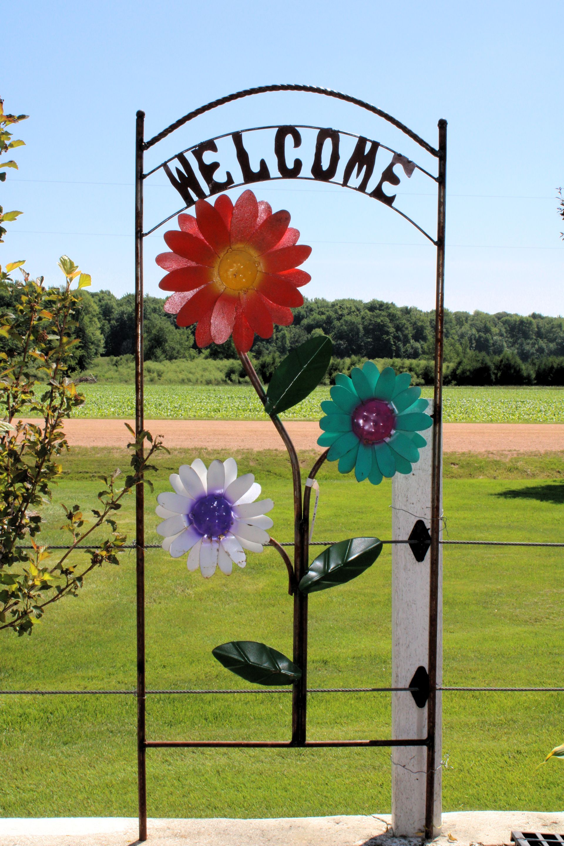 Metal sign with colorful flowers and 