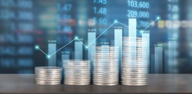 Stacks of coins with rising bars and a line graph on a blue financial market background