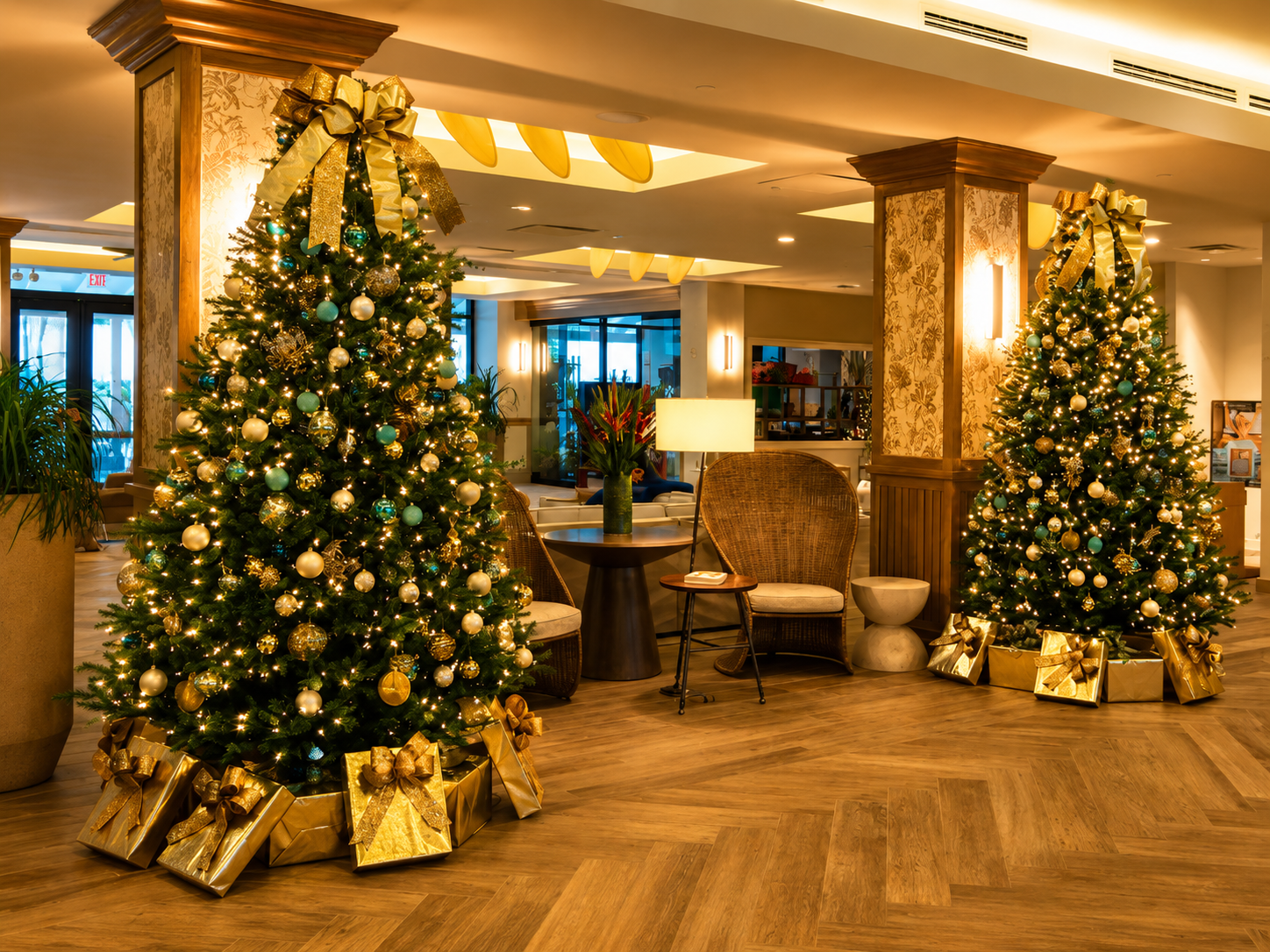 Festive hotel lobby with two decorated Christmas trees and warm lighting