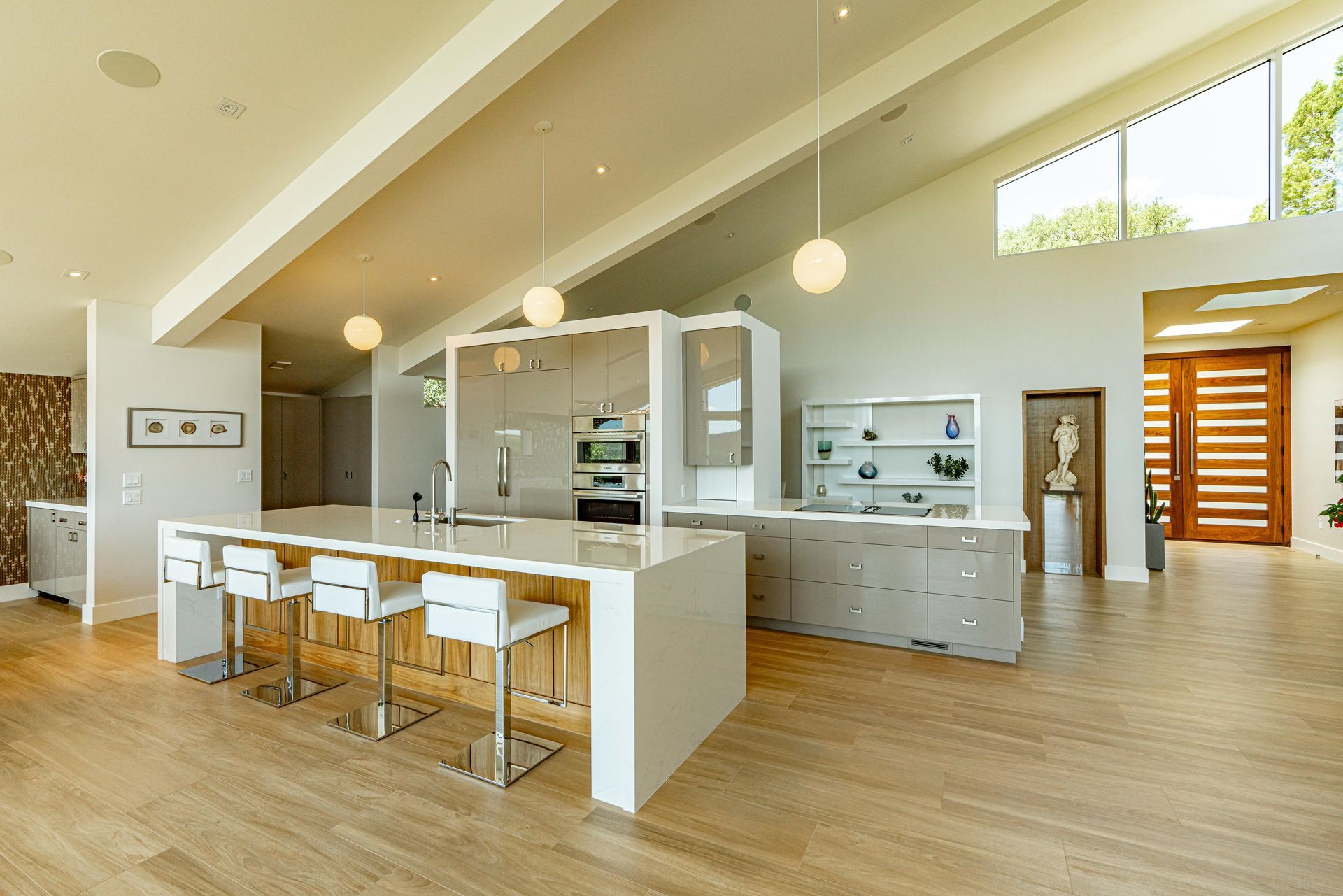 A modern kitchen with a large island and stools