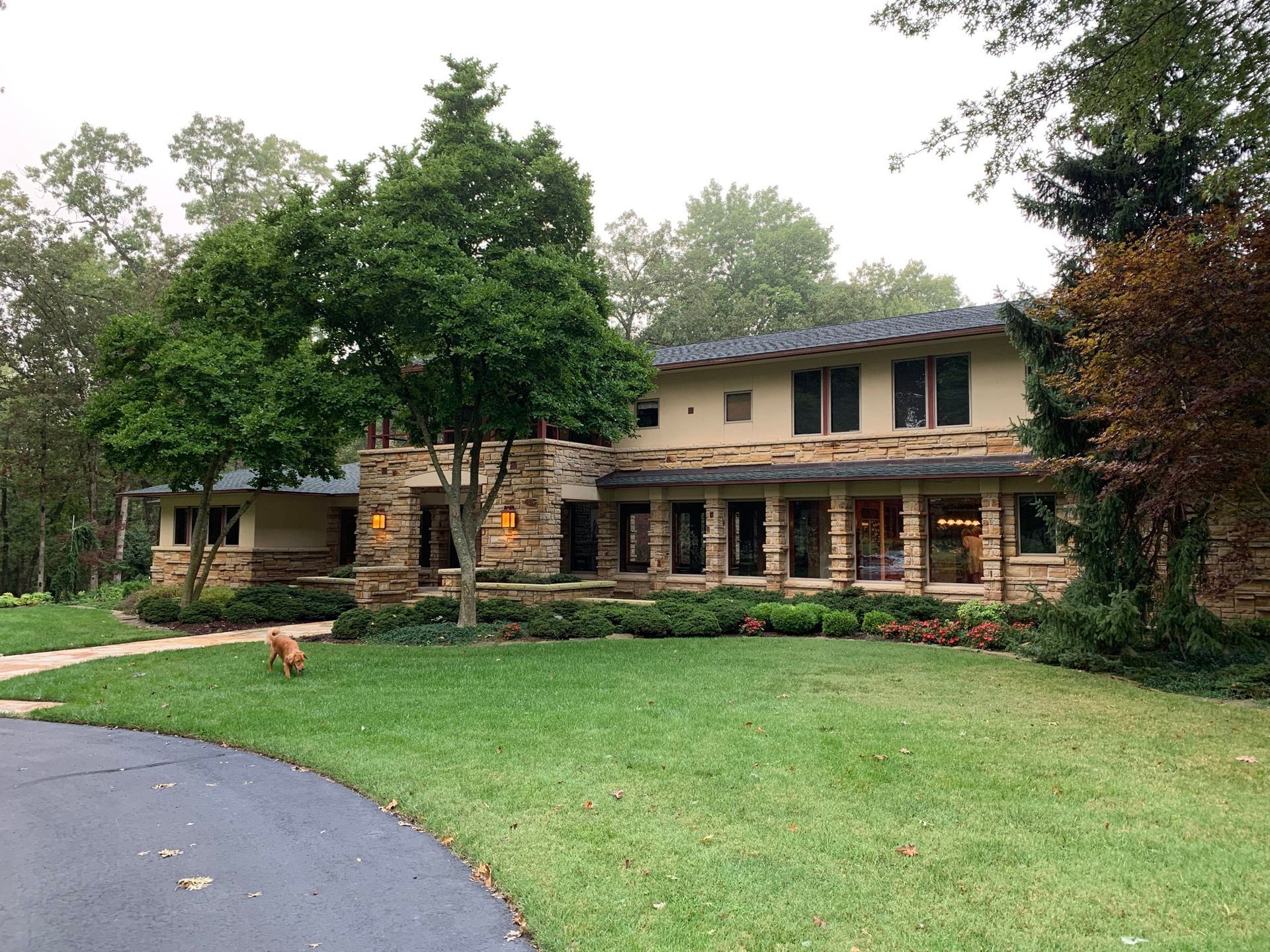 A large house with a lot of windows and trees in front of it