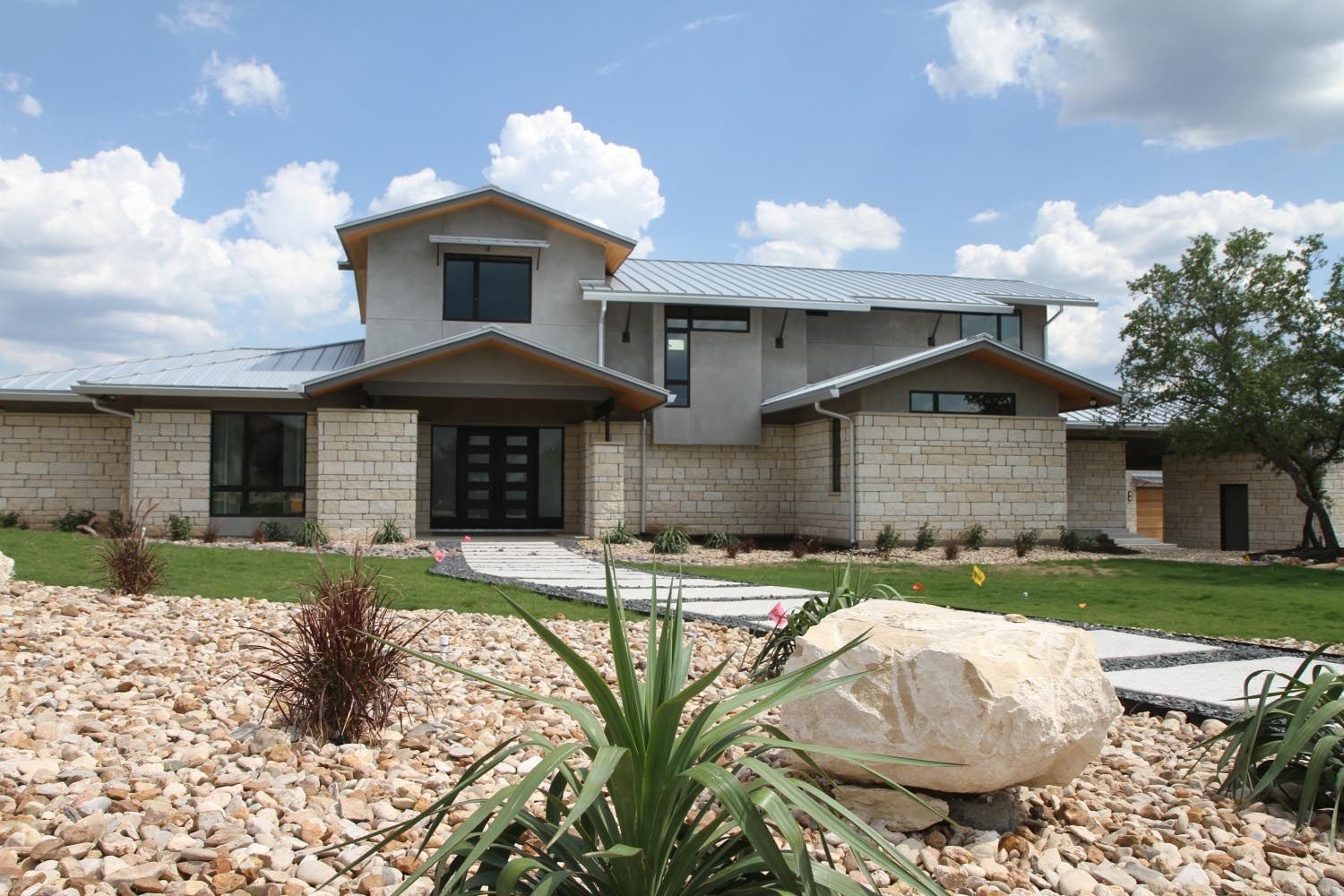 A large house with a lot of rocks in front of it