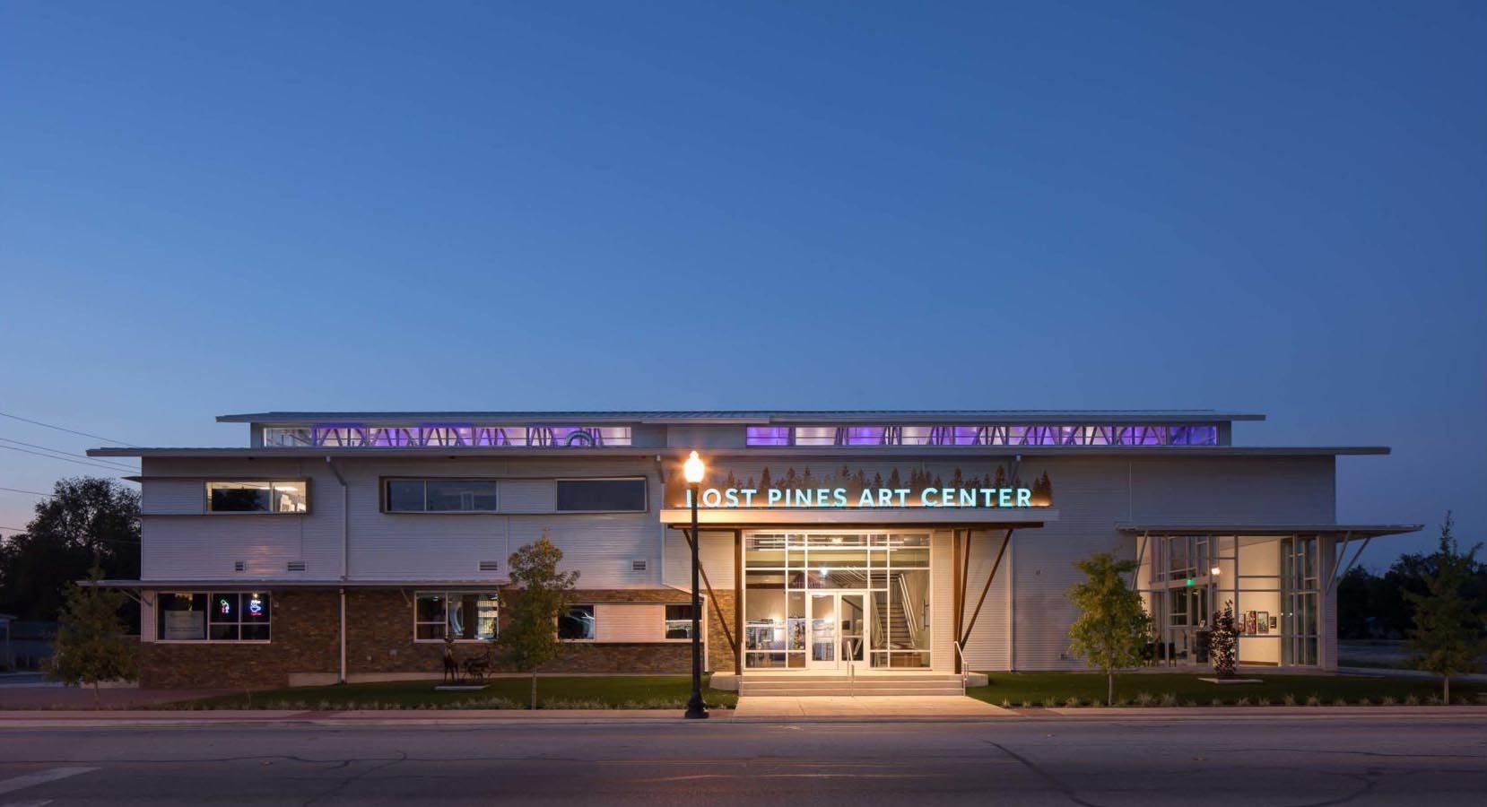A large white building with a sign that says dolphins are center