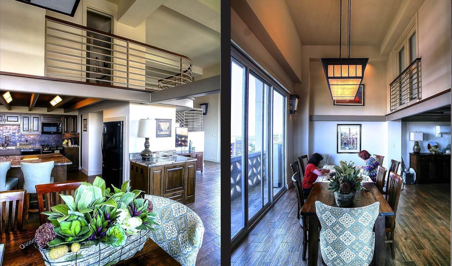 Open-concept dining and kitchen area with a loft. Dining table with people near sliding glass doors.