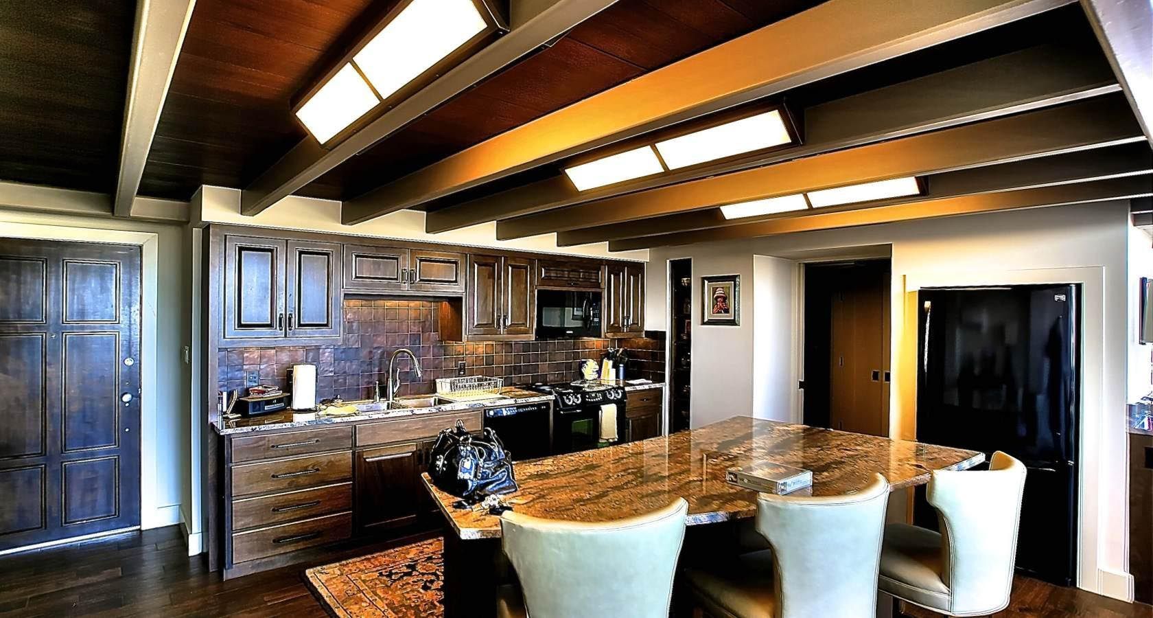 A kitchen with a table and chairs in it