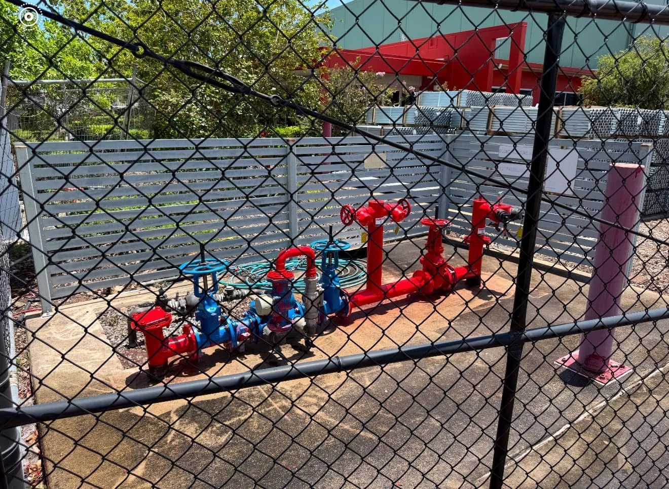 Colourful Outdoor Playground Water Pump Station Behind a Chain-link Fence — Flaming North Fire Protection Pty Ltd in Atherton Tablelands, QLD